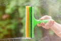 Window cleaner using a squeegee to wash a window. Clean horizontal bar Royalty Free Stock Photo