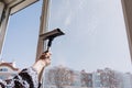 Window cleaner using a squeegee to wash a window