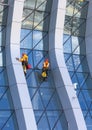 Window cleaner working on a glass facade modern skyscraper