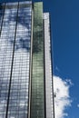 A skyscraper with window-cleaners high up.