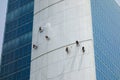 Window cleaners washing an office blocks exterior facade Royalty Free Stock Photo