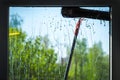 Window cleaning using telescopic water brush and wash system Royalty Free Stock Photo