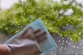 Window cleaning. Window cleaning with a special rag. Window cleaning at home with a blue napkin.Rectangular gloves Royalty Free Stock Photo