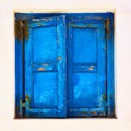 Window with closed blue shutters in Mykonos