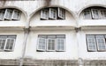 Old dirty building with windows and arch.