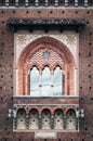 Window closeup of clock tower of Sforza Castle (Castello Sforzesco), one of the main landmarks and tourist attractions of Milan,