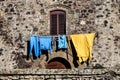 Window and clothes hanging. Wall facade old house.