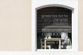 Window of a coffee shop with the names of different kinds of coffees on it Royalty Free Stock Photo