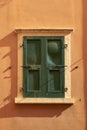 Window of a colorful house with green closed shutters in Malcesine in Italy Royalty Free Stock Photo