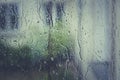 Window covered in raindrops after the heavy rain in the evening Royalty Free Stock Photo