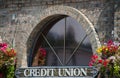 Window of a credit union surrounded by flower baskets