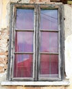 Window at creepy house in ruins with fallen plaster and exposed bricks with window