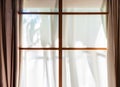 a window with curtains and light coming in from the top Royalty Free Stock Photo