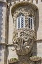 Window decorated with grotesque gargoyle on a facade of the Palacio da Pena Royalty Free Stock Photo