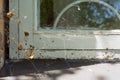 Window detail in the house with a white wooden cracked frame and wrapped in cobweb Royalty Free Stock Photo