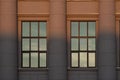 The window detail of the library framed by three collumns, split by the sunset