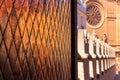 Window with diagonal-shaped patters and stone statues on the top of the cathedral Royalty Free Stock Photo