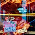 Window display of a British butcher showing various types of meat and their prices, London, UK Royalty Free Stock Photo