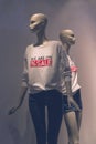 Window display with five mannequins wearing t-shirts