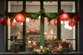 window display with red and green lanterns, wreath, and bow on a white curtain