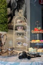 Window display with variety of beautiful tea cups, saucers and fruit, Saratoga Tea and Honey, Downtown Saratoga, NY, summer, 2022