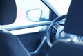 Window on the driver`s side and rear view mirror.Steering and instrument panel in the car close-up. Left-hand drive