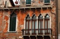 Window facade with balcony of old house in Italy Venice historic