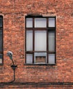 Window on the facade of an old brick building. Loft-style architural