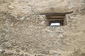 Window on the faÃÂ§ade of a stone wall Royalty Free Stock Photo