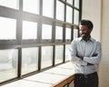 Window, flare and a business man arms crossed in the office with a smile or mindset of future success. Happy, vision and Royalty Free Stock Photo