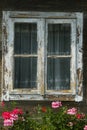 Window with flowers on an old wooden house in Kutina, Croatia