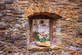 Window with flowers, medieval castle Zborov, Slovakia. Autumn time Royalty Free Stock Photo