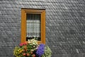 Window with Flowers in a Slate Wall Royalty Free Stock Photo