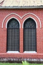 Window frame and red brick of exterior of main church at cathedral of the holy trinity. Royalty Free Stock Photo