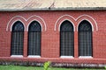 Window frame and red brick of exterior of main church at cathedral of the holy trinity. Royalty Free Stock Photo