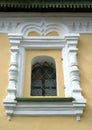 Window in a frame of a stone platband. A fragment of church of Christmas of John the Forerunner on Volga, the 17th century. Uglich