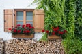 Window with geraniums on exterior wall Royalty Free Stock Photo