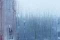Window glass with condensation, strong, high humidity in the room, large water droplets flow down the , cold tone Royalty Free Stock Photo