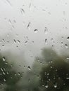 Rain-dropped window viewed from inside, with a blurred, gloomy outside world. Royalty Free Stock Photo
