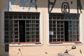 Window glass, iron square. Antique construction, graffiti on the wall. Urban characteristic Royalty Free Stock Photo