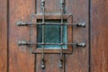 Window with grate in old wooden door Royalty Free Stock Photo