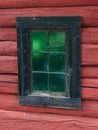 Window with green glass of an old log house at Valdresmusea Folk