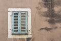 Window with green window shutter in an old ramshackle house Royalty Free Stock Photo