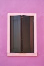 Window with green shutter on pink wall. Italy, Venicw, Burano Royalty Free Stock Photo