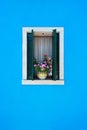 Window with green shutters and pink flowers in the pot. Italy, Venice, Burano Royalty Free Stock Photo