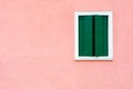 Window with green shutters on the pink wall Royalty Free Stock Photo