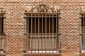 Window with grill on a brick wall Royalty Free Stock Photo