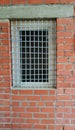 Window grille on brick wall