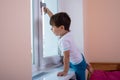 Kids trying to open the window pulling its handle. Child Safety Window Restrictors in the Home.