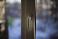 Window handle. Plastic windows in the apartment. Handle for opening the window for ventilation. The closed window is white. Royalty Free Stock Photo